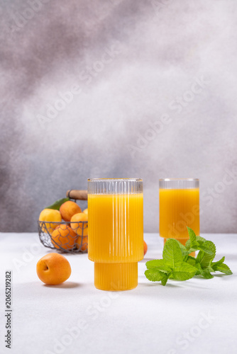 Fresh apricot juice in glasses with fruit and mint