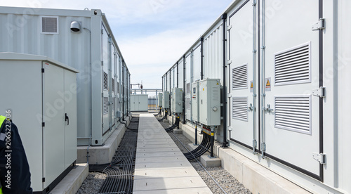 Obraz na płótnie Modern energy storage containers lined up with electrical equipment and cables