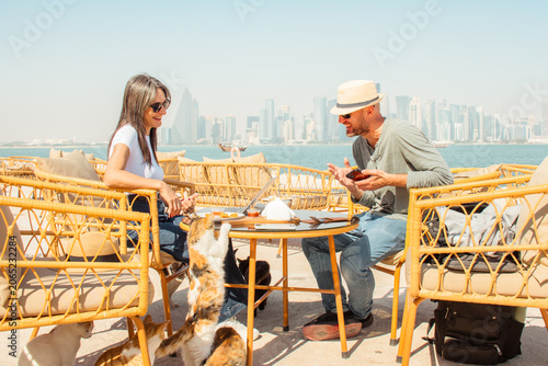 Bild auf Leinwand Close up Man and woman sitting in outdoor cafe Doha Corniche