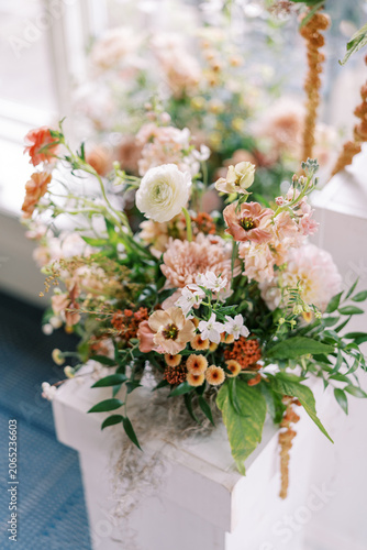 Elegant pastel wedding floral arrangement with ranunculus and chrysanthemums