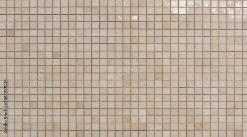Seamless tile mosaic background with soft light reflections. Evenly spaced small square tiles form a structured, elegant pattern with subtle gloss.
