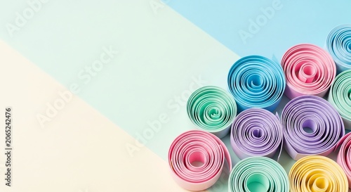 Pastel paper rolls arranged on a split color background