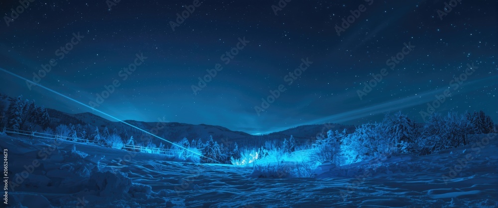 Naklejka premium Nighttime snowy landscape illuminated by bright blue neon rays beneath starry sky