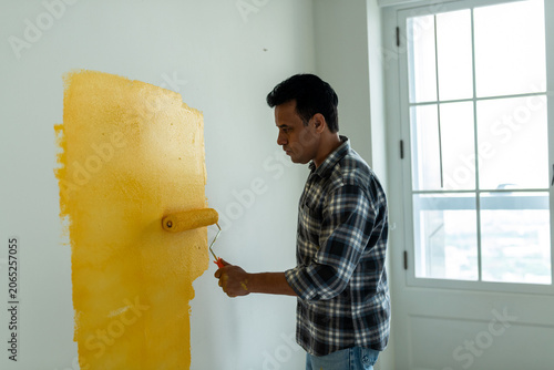 Photography Man painting wall yellow indoors