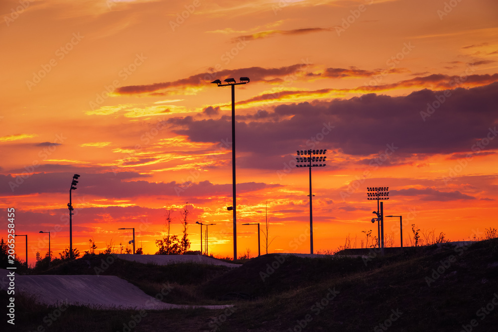 Naklejka premium Sunset at the BMX track (bicycle motocross racing track) at Lee Valley VeloPark in Stratford, East London, UK, with a moody sky