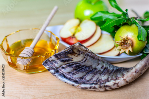 Rosh hashanah offerings with shofar, honey, apples, and pomegranate