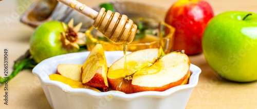 Pouring honey on apples for rosh hashanah celebration