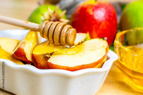 Jewish new year apples with honey dipper