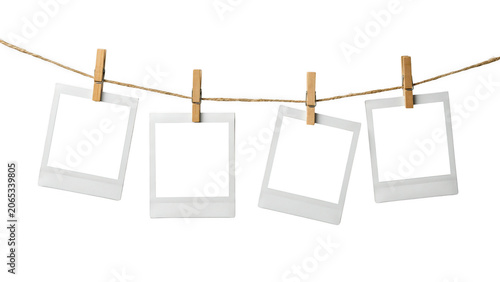 Four blank polaroid photos hanging on a rope with clips isolated on transparent background