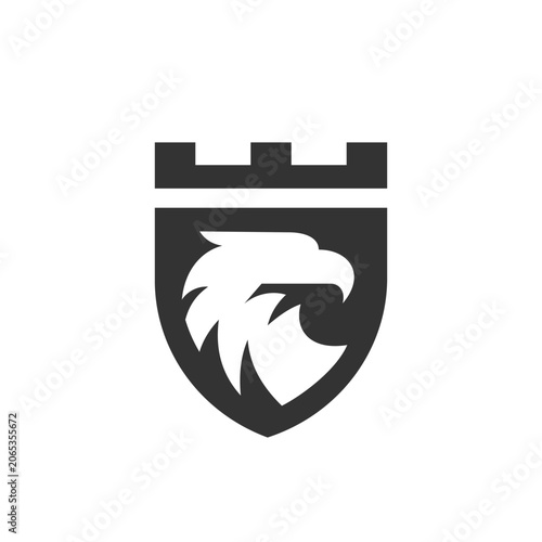 Stylized eagle head within a castle battlement shield.