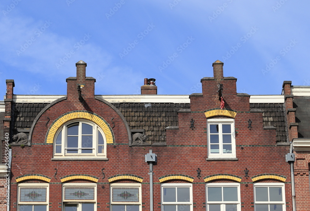 Naklejka premium Amsterdam Marnixstraat Brick Building Facade with Different Gables Close Up, Netherlands