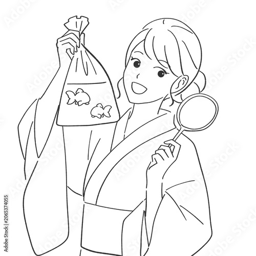 金魚すくいで金魚を釣る浴衣を着た女性
