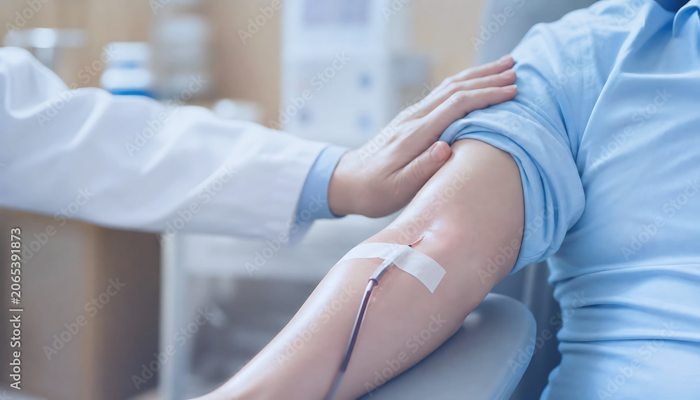 Fototapeta premium Closeup of a healthcare professional comforting a patient during a blood donation procedure