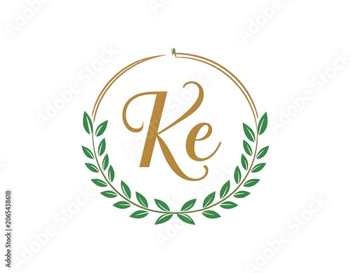 Elegant gold logo with green laurel leaves and stylized text
