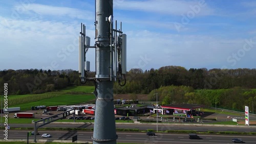 Aerial Drone Footage of 5G Cell Tower at Motorway Service Area with Truck Parking and Gas Station