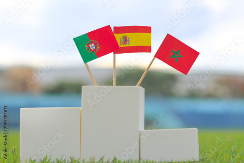 Cuadro en lienzo Portugal Spain and Morocco flags on a white winner podium on grass
