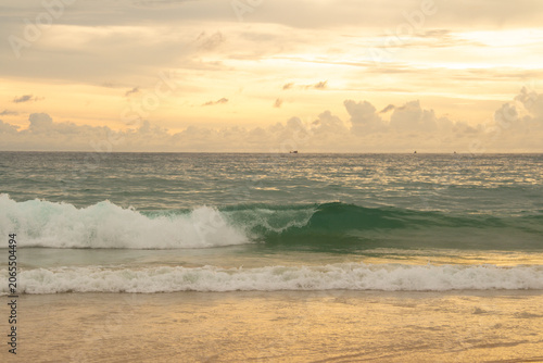 Photography Golden sunset over calm sea with dramatic clouds and colorful sky reflected on w