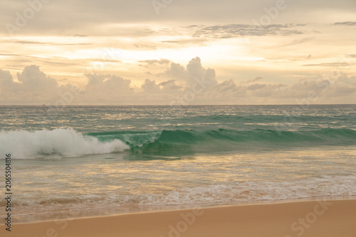 Photography Golden sunset over calm sea with dramatic clouds and colorful sky reflected on w
