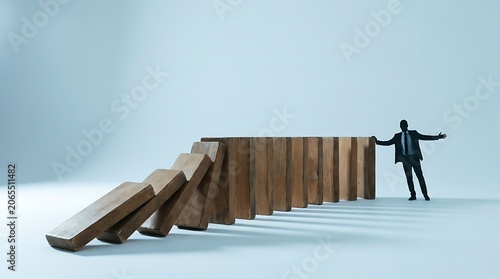 Businessman stopping falling wooden dominoes representing challenge with business challenge strategy management solution