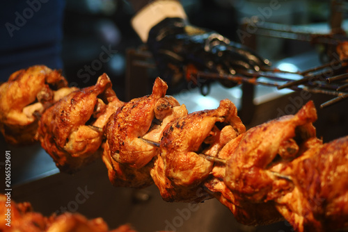 Grilling chicken on skewers at a street food stall
