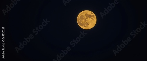 Bright full moon against a dark night sky