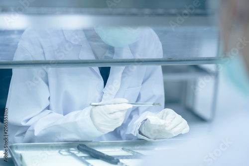 Obraz na plátně Histopathology technician preparing tissue biopsy for microscopic processing