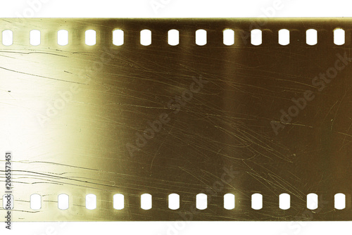 Dusty and grungy 35mm film texture or surface. Perforated scratched camera film isolated on white background.