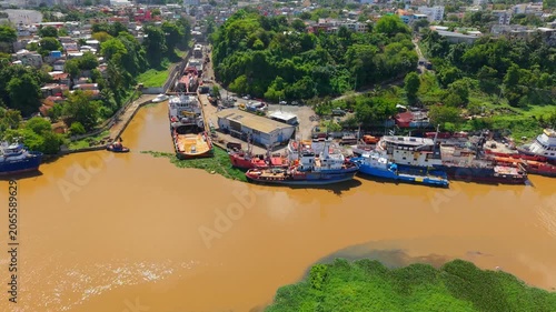 Aerial View of Cargo Ships Docked at an Urban River Port