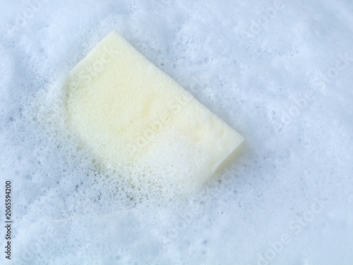 Obraz na płótnie Kitchen sponge floating in rich white soap foam and bubbles