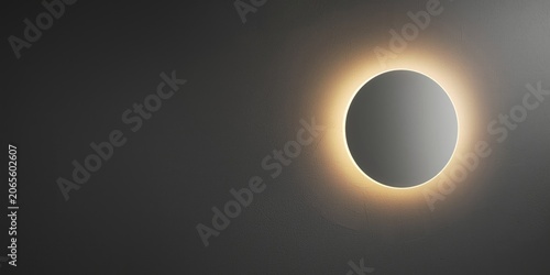 Textured gray wall as ambient lighting background enhanced by a glowing round mirror