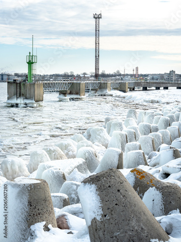 protective rocks of the breakwater covered with ice