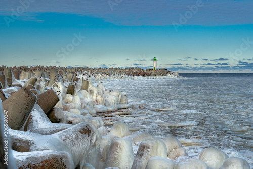 protective rocks of the breakwater covered with ice