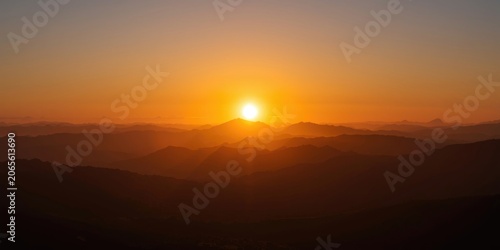 Radiant sunrise over mounta...