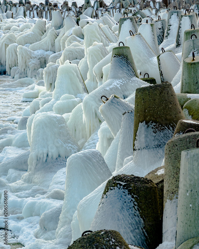 protective rocks of the breakwater covered with ice