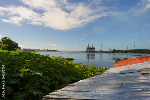 Konstfotografi Scenic view of an industrial seaside power plant reflected in calm water behind