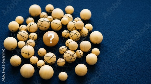 Wooden network with question mark symbol illustrating complex logic and doubt