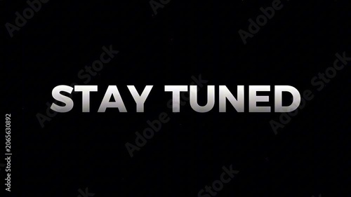 Bold 'STAY TUNED' message in metallic silver letters on a deep black background, signaling forthcoming content, announcements, or a broadcast