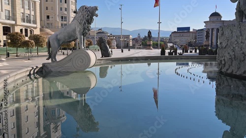 Lion statue fountain reflecting Macedonia Square in Skopje