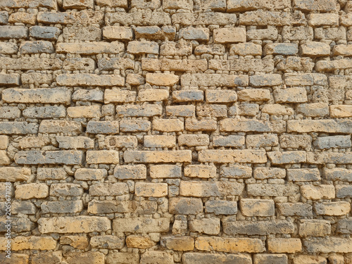 Ancient walls made of bricks glued together with clay