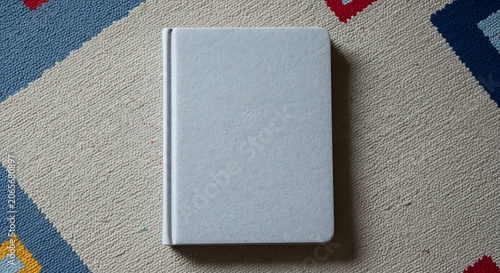 Minimalist grey notebook on patterned fabric background mockup, blank spaces for text