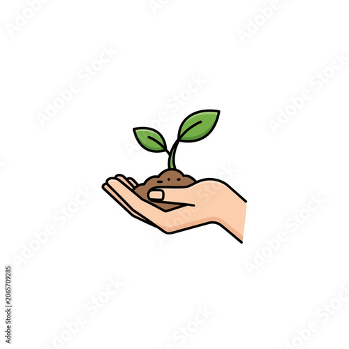 Hand holding a green plant sprout in soil