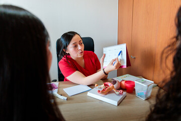 Midwife using calendar for reproductive health education