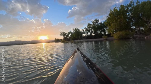 Immersive POV from a kayak - paddling on Boedecker Reservoir in Loveland, Colorado, with sunset over Rocky Mountains