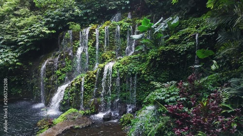 Waterfall with lush tropical plants. Banyu Wana Amertha Waterfall in Bali.