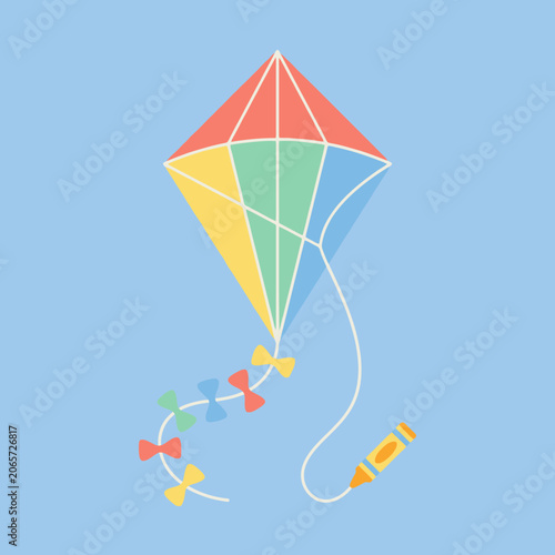 A colorful kite flying against a soft blue sky background