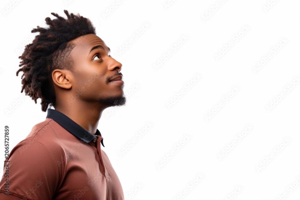 Obraz premium Young man with dreadlocks looking up, expressing hopeful future and curiosity