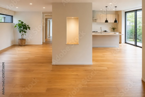 Modern empty living room interior with wooden floor, large window, natural light and contemporary home design space