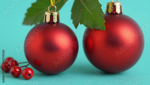 Red Christmas ornaments with green leaves and berries.