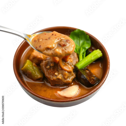 Traditional Filipino kare-kare oxtail stew with thick peanut sauce, vegetables, and bagoong.