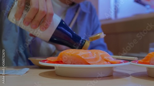Hands Using Chopsticks to Pick Up Japanese Food. Close-Up of Authentic Asian Dining Experience